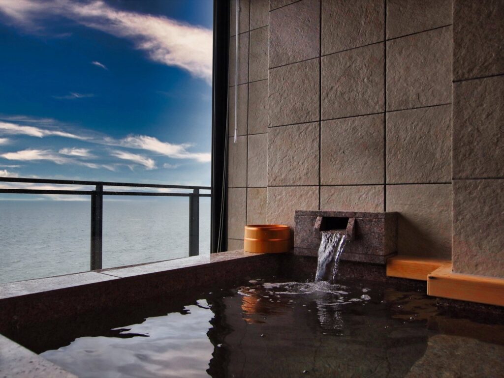 A guest-room bath overlooking Kinko Bay at Ibusuki Hakusuikan