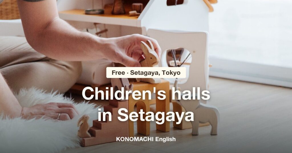 Wooden toy animals and a hand playing on the floor